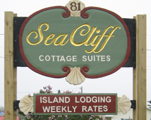 Sign for SeaCliff Cottage Suites offering island lodging with weekly rates